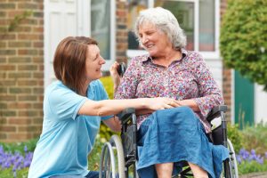 Woman assisting resident in wheelchair