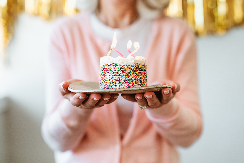 Alavida Lifestyles Senior woman holding birthday cake